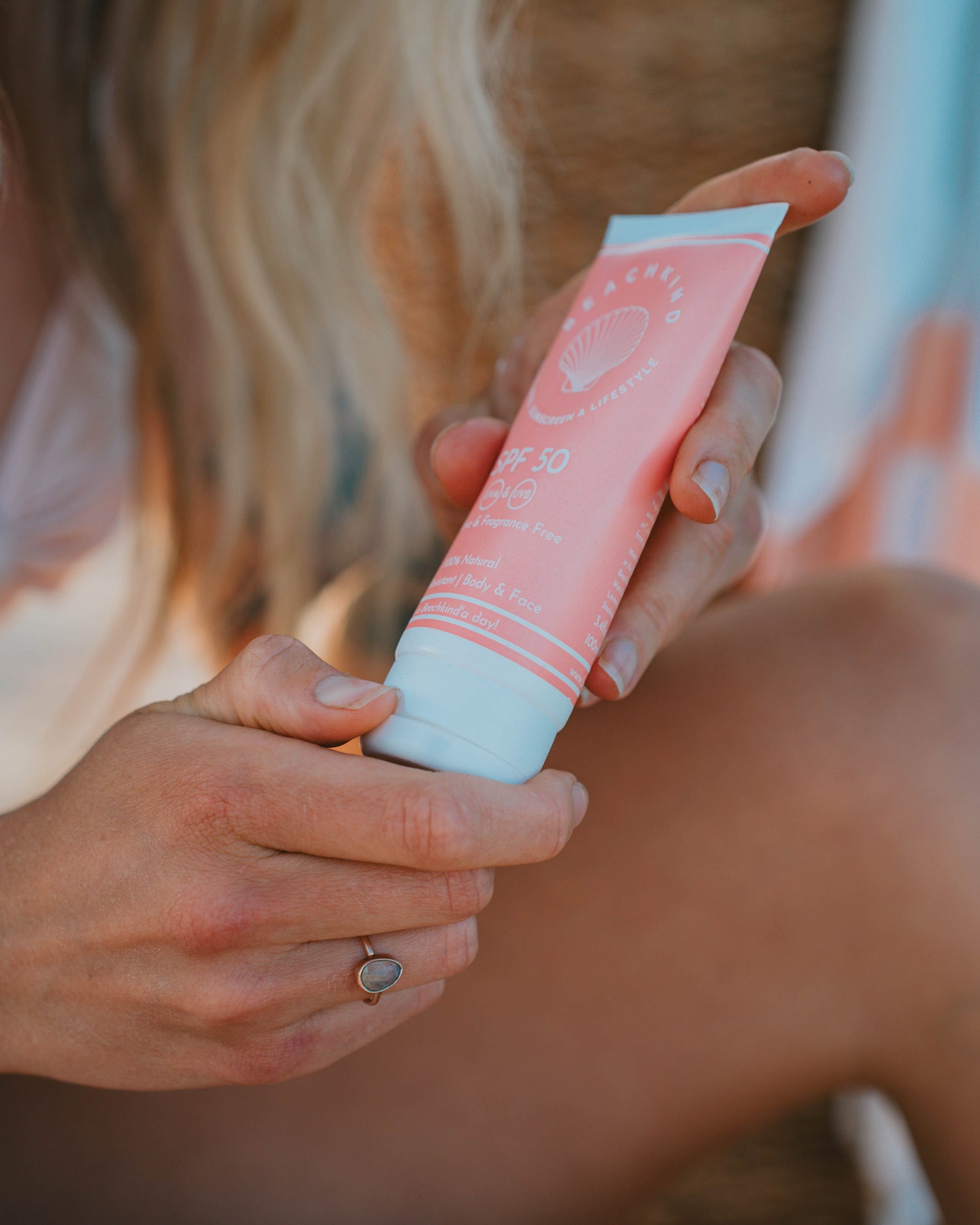 woman's hand and sunscreen